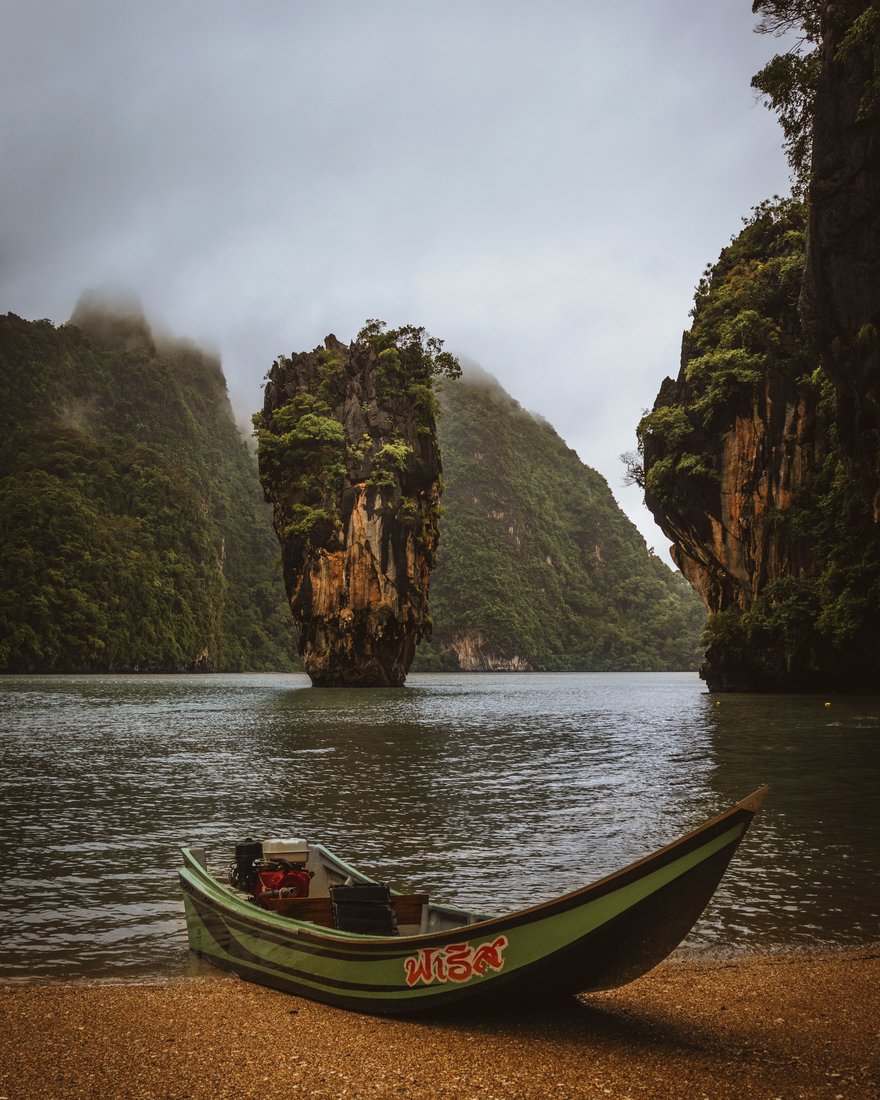 A longtail boat below the limestone karsts of Phang Nga Bay, Thailand